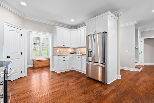 1462 Turn Lake Dr, Auburn, AL 36830 - kitchen featuring appliances with stainless steel finishes, ornamental molding, white cabinetry, dark wood finished floors, and light stone countertops