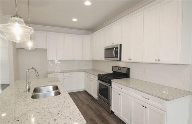 kitchen featuring appliances with stainless steel finishes, light stone countertops, sink, and white cabinets