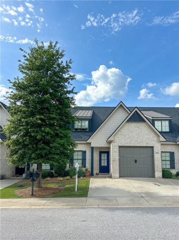 1391 Sheridan Glen Xing, Auburn, AL 36830 - view of front of house with concrete driveway, an attached garage, brick siding, and a shingled roof