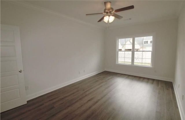 spare room featuring dark wood-type flooring, ceiling fan, and crown molding