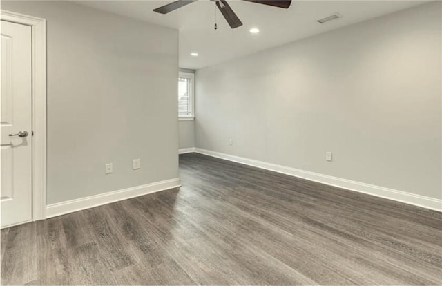 empty room with ceiling fan and dark hardwood / wood-style flooring