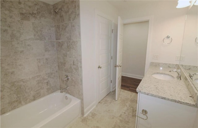 bathroom featuring vanity and tiled shower / bath combo