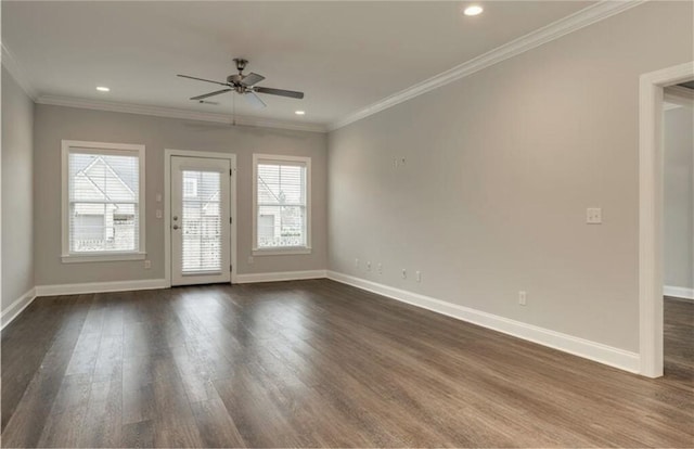 unfurnished room featuring crown molding, plenty of natural light, dark wood-type flooring, and ceiling fan