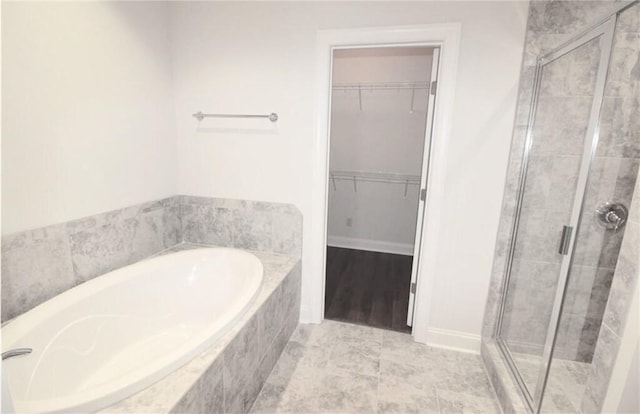 bathroom featuring separate shower and tub