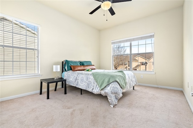 bedroom featuring ceiling fan and light colored carpet