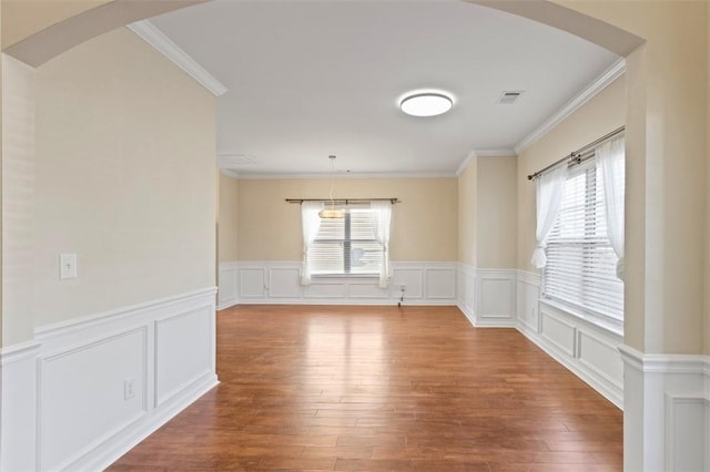 spare room with arched walkways, visible vents, and a wealth of natural light