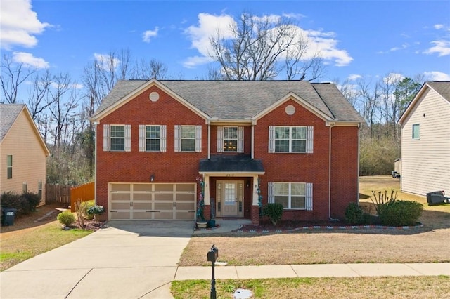 view of front of house featuring an attached garage, brick siding, fence, driveway, and a front lawn