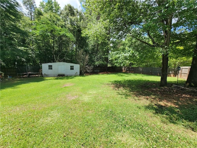 2580 Lee Road 148, Opelika, AL 36804 - view of yard with a trampoline, an outbuilding, a shed, and view of wooded area