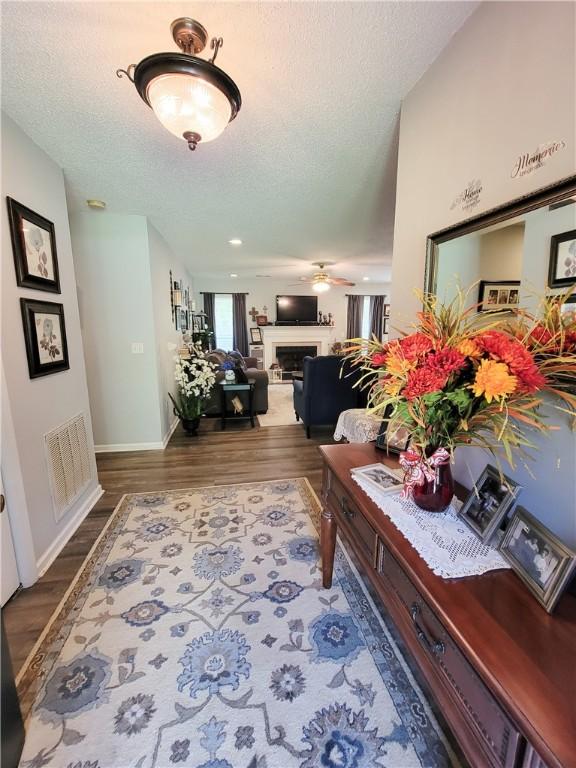 2580 Lee Road 148, Opelika, AL 36804 - corridor featuring a textured ceiling, wood finished floors, and baseboards