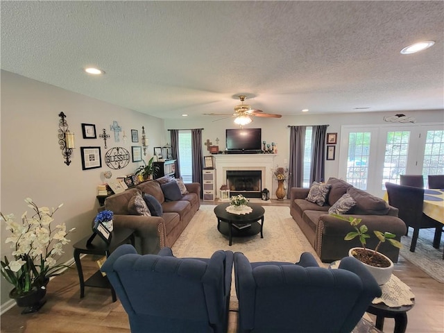 2580 Lee Road 148, Opelika, AL 36804 - living room featuring a textured ceiling, plenty of natural light, recessed lighting, wood finished floors, and ceiling fan