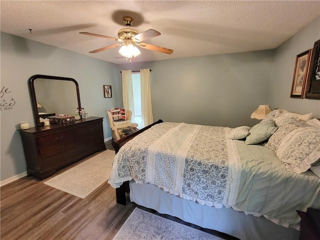 2580 Lee Road 148, Opelika, AL 36804 - bedroom with wood finished floors, a textured ceiling, ceiling fan, and baseboards