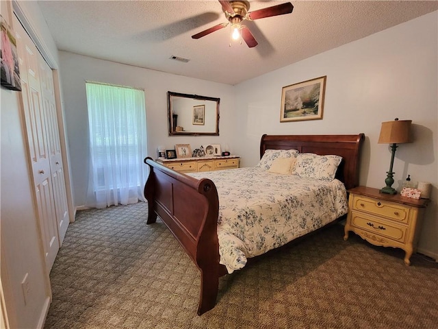 2580 Lee Road 148, Opelika, AL 36804 - carpeted bedroom featuring a closet, a ceiling fan, and a textured ceiling