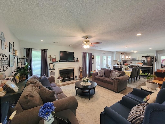 2580 Lee Road 148, Opelika, AL 36804 - living area with a ceiling fan, a textured ceiling, healthy amount of natural light, a fireplace with flush hearth, and recessed lighting
