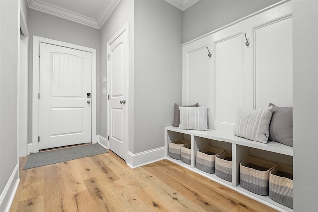 mudroom with wood-type flooring and crown molding