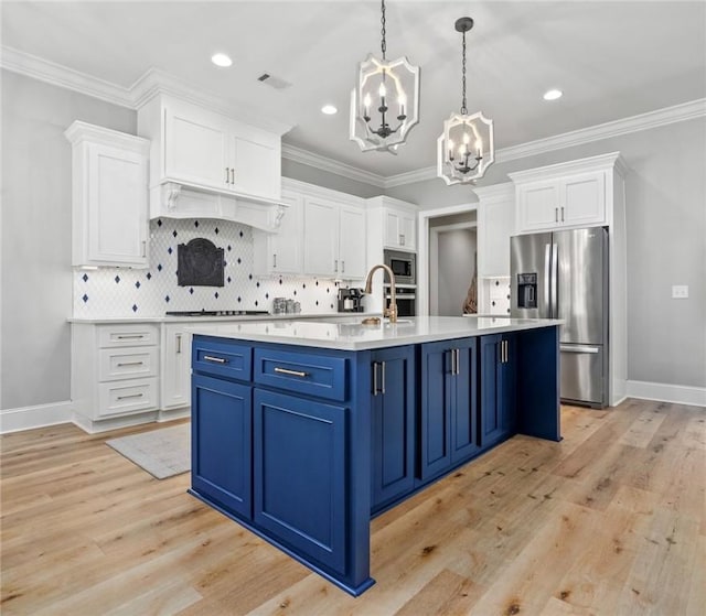 kitchen featuring blue cabinetry, white cabinets, a chandelier, and appliances with stainless steel finishes