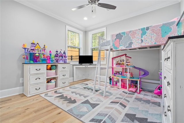 recreation room with ceiling fan, light hardwood / wood-style floors, and crown molding