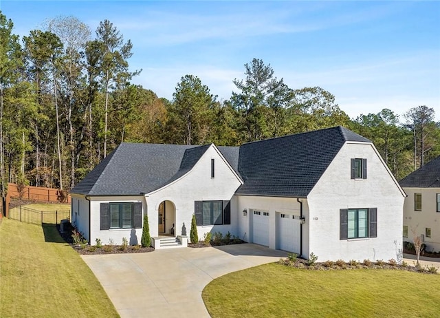 french provincial home with a garage and a front lawn