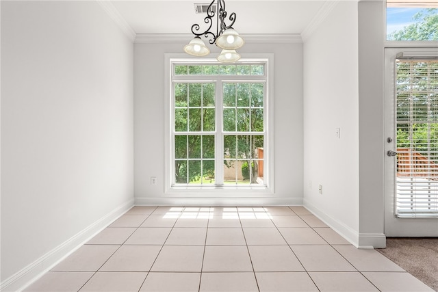 unfurnished dining area with an inviting chandelier, ornamental molding, and light tile patterned flooring