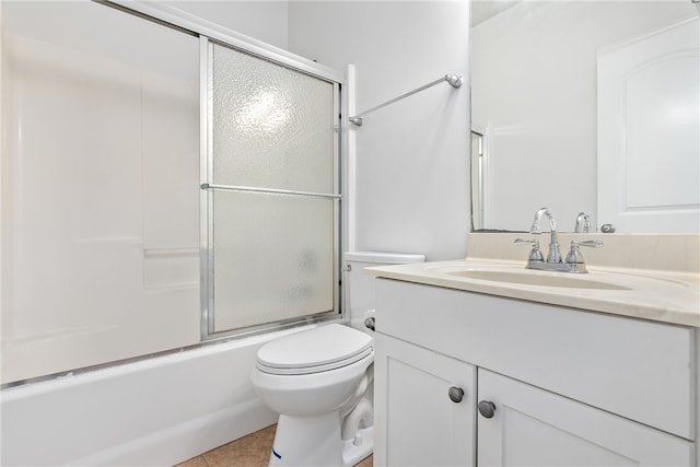 full bathroom featuring shower / bath combination with glass door, tile patterned floors, vanity, and toilet