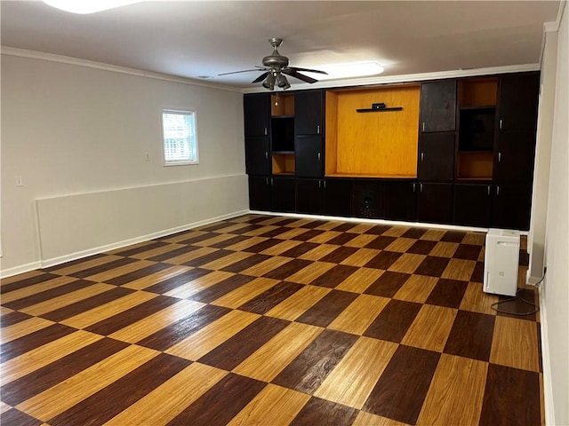 spare room featuring ceiling fan and crown molding