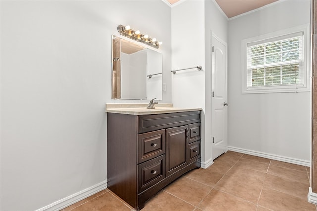 bathroom with tile patterned floors, vanity, and crown molding