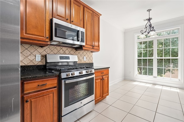 kitchen with a notable chandelier, appliances with stainless steel finishes, decorative backsplash, light tile patterned flooring, and ornamental molding