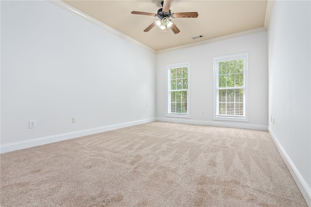 carpeted spare room with ceiling fan and ornamental molding