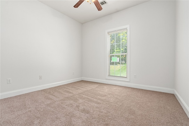 unfurnished room with ceiling fan and carpet