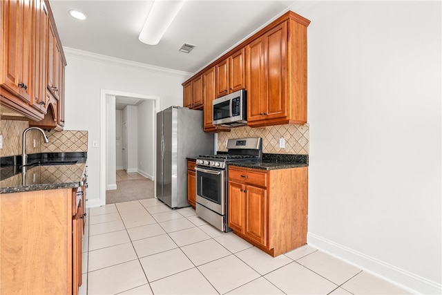 kitchen with backsplash, dark stone counters, stainless steel appliances, crown molding, and sink