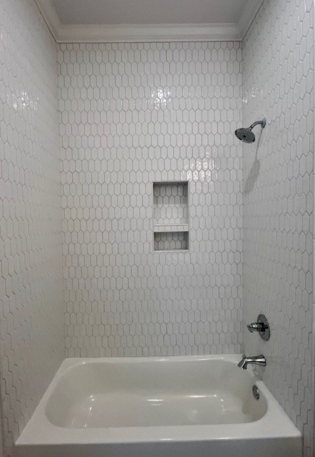 bathroom featuring shower / bathtub combination and ornamental molding