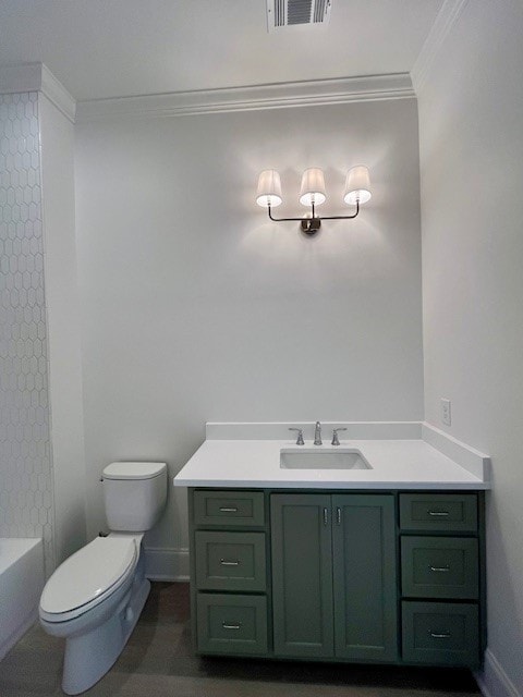 bathroom with vanity, ornamental molding, and toilet