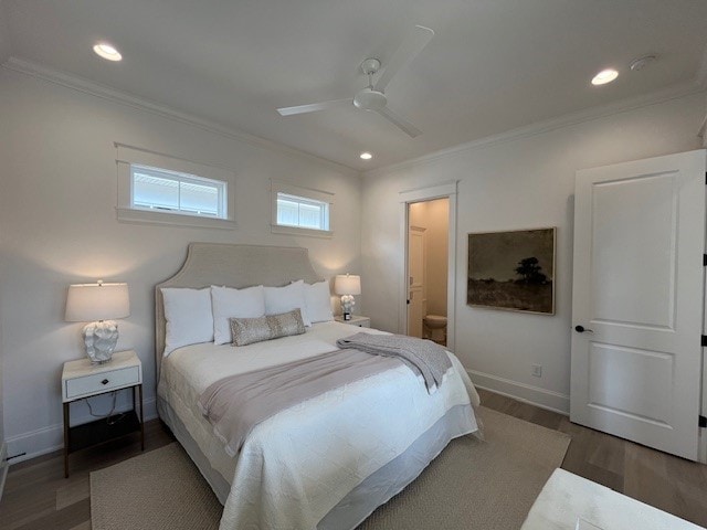 bedroom with crown molding, ceiling fan, ensuite bathroom, and dark hardwood / wood-style floors