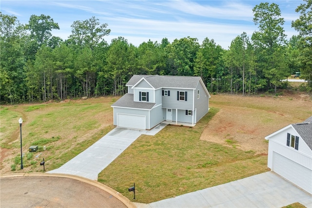 view of front of home with a garage and a front yard