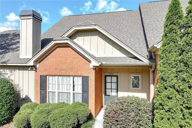 1630 Academy Dr Unit 404, Auburn, AL 36830 - view of front of home with board and batten siding, brick siding, and a shingled roof