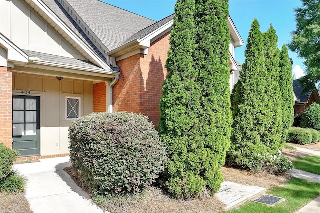 1630 Academy Dr Unit 404, Auburn, AL 36830 - view of side of property featuring board and batten siding, brick siding, and roof with shingles