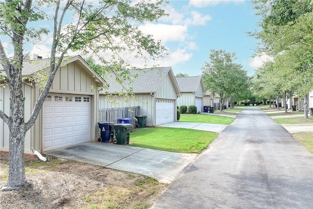 1630 Academy Dr Unit 404, Auburn, AL 36830 - view of front of property with board and batten siding, a front yard, and roof with shingles