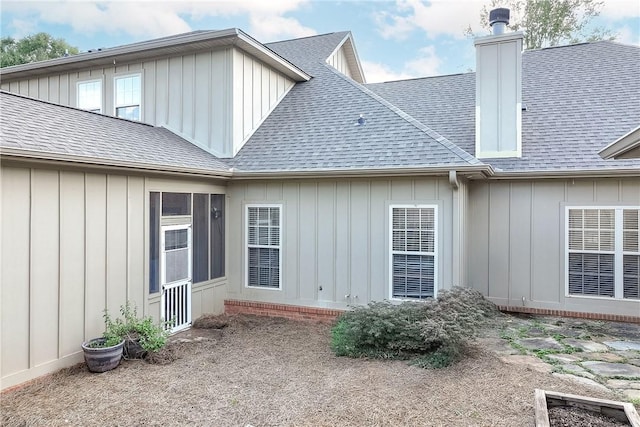 1630 Academy Dr Unit 404, Auburn, AL 36830 - rear view of house featuring a shingled roof, board and batten siding, and a chimney