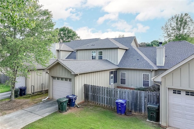 1630 Academy Dr Unit 404, Auburn, AL 36830 - view of front of property with a shingled roof, concrete driveway, an attached garage, board and batten siding, and a chimney