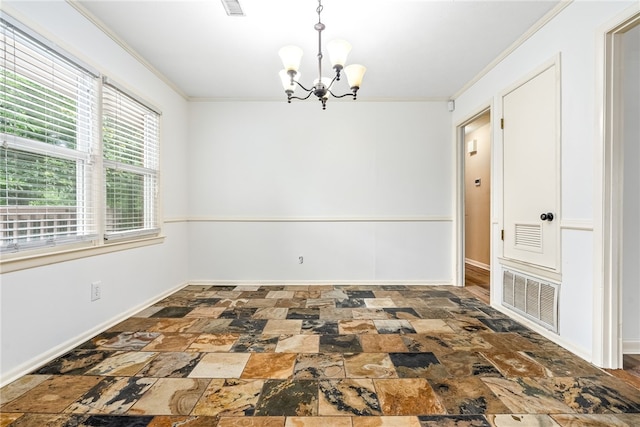630 Apache St, Auburn, AL 36830 - spare room with stone tile flooring, a chandelier, and crown molding
