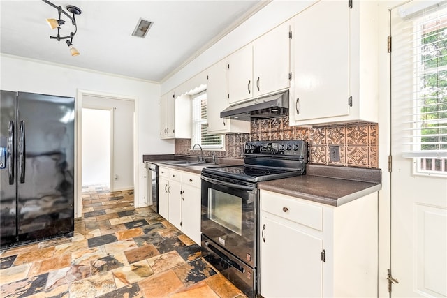 630 Apache St, Auburn, AL 36830 - kitchen featuring black appliances, under cabinet range hood, dark countertops, stone finish flooring, and ornamental molding