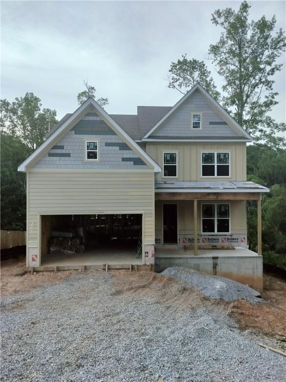 view of front of house featuring covered porch and a garage