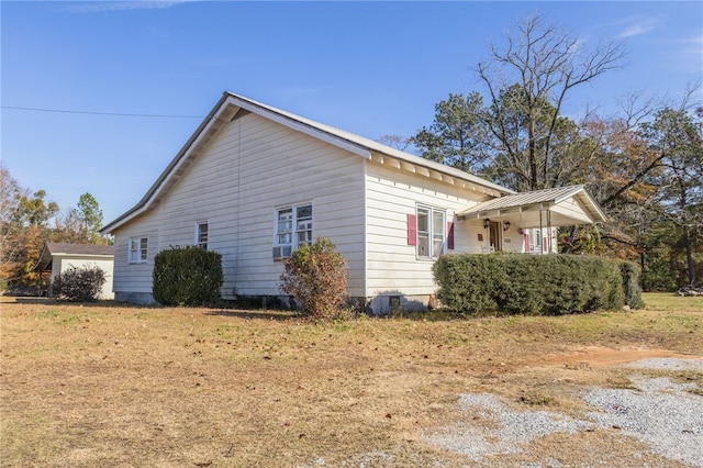 view of side of home with a yard