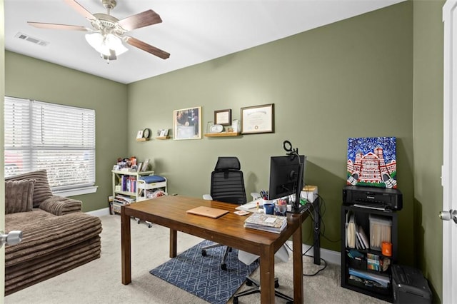 carpeted office space featuring ceiling fan