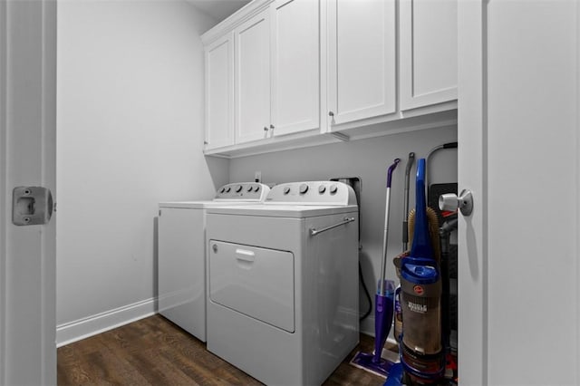 clothes washing area with cabinets, dark hardwood / wood-style floors, and separate washer and dryer