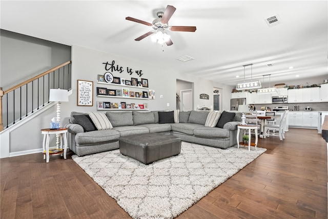 712 Mcdonald Dr, Opelika, AL 36801 - living area featuring ceiling fan, stairway, visible vents, and dark wood-style floors