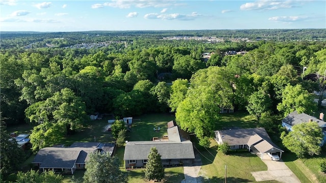 view of property location with a heavily wooded area
