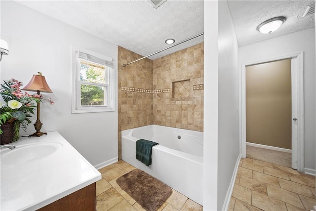 full bathroom with shower / bath combination, baseboards, a textured ceiling, and vanity