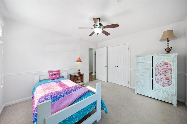 carpeted bedroom featuring baseboards, a closet, and a ceiling fan