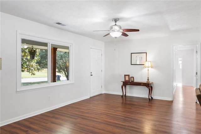 foyer entrance featuring visible vents, wood finished floors, baseboards, and ceiling fan