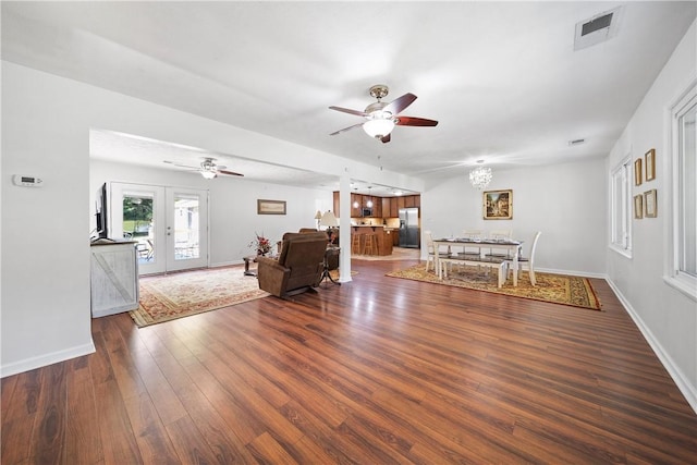 living area featuring ceiling fan, dark wood-style flooring, baseboards, and visible vents